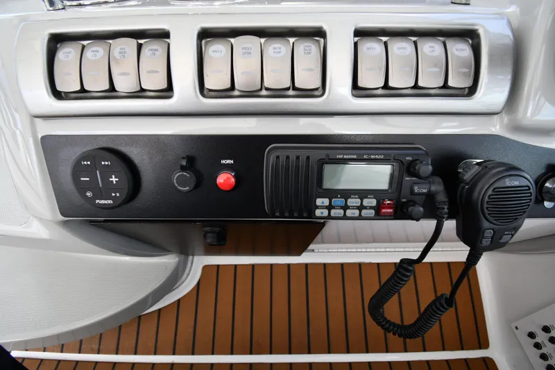 Slide: The Image of Control panel of a 2009 Formula 40 PC boat with radio and switches. - 17