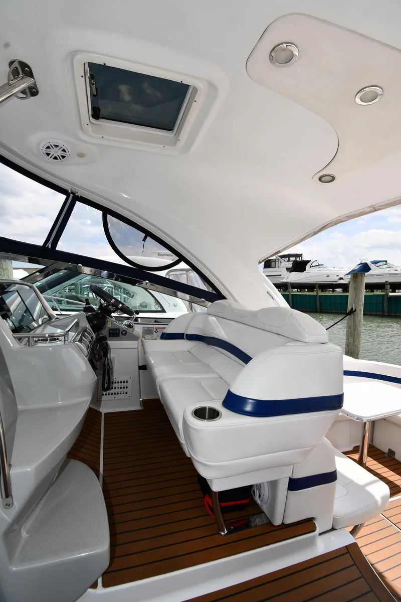 Slide: The Image of 2009 Formula 40 PC yacht interior with white seating and wooden flooring, docked at marina. - 19