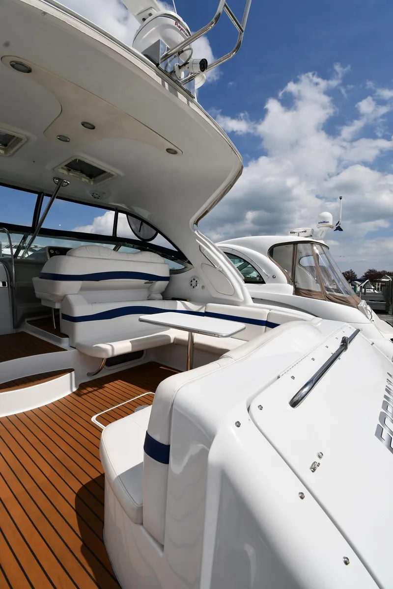 Slide: The Image of 2009 Formula 40 PC yacht with sleek design and wooden deck under a blue sky. - 22