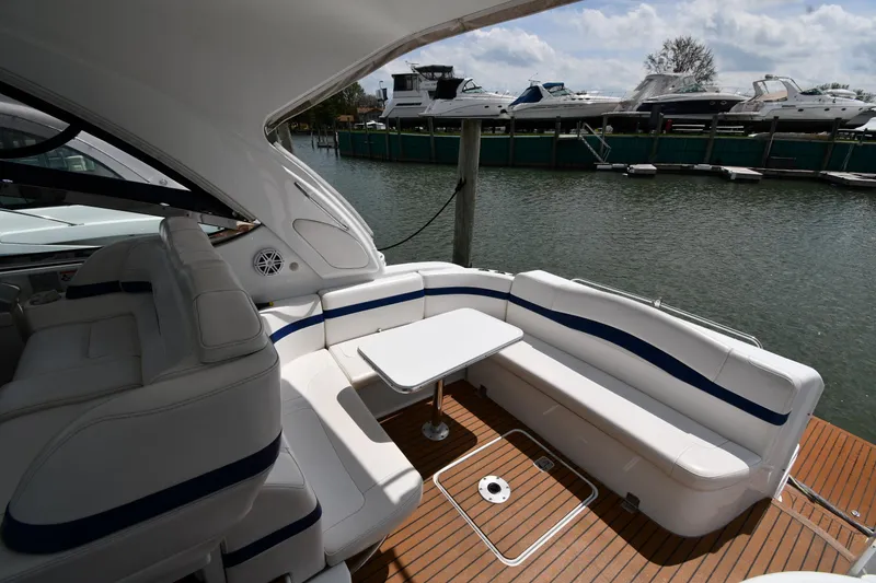 Slide: The Image of 2009 Formula 40 PC yacht with white seating and table, docked by the water. - 26
