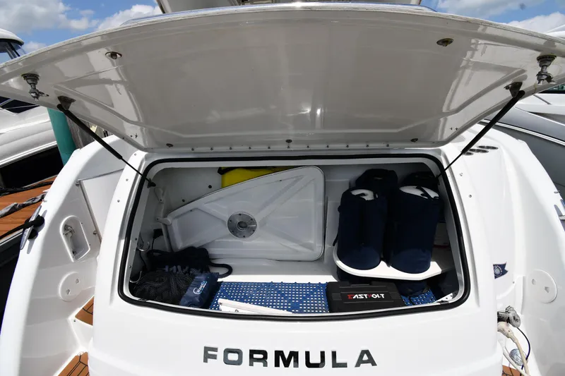 Slide: The Image of Open storage compartment of 2009 Formula 40 PC boat with various boating accessories. - 30