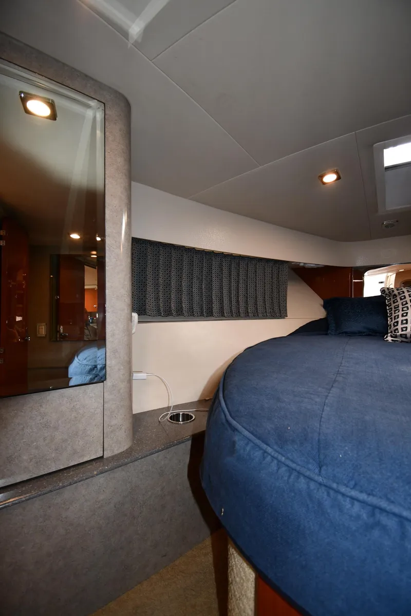 Slide: The Image of Interior cabin of 2009 Formula 40 PC yacht with blue bedding and modern lighting. - 36