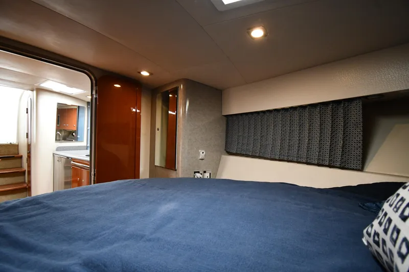 Slide: The Image of 2009 Formula 40 PC yacht interior cabin with bed, modern lighting, and wooden accents. - 38