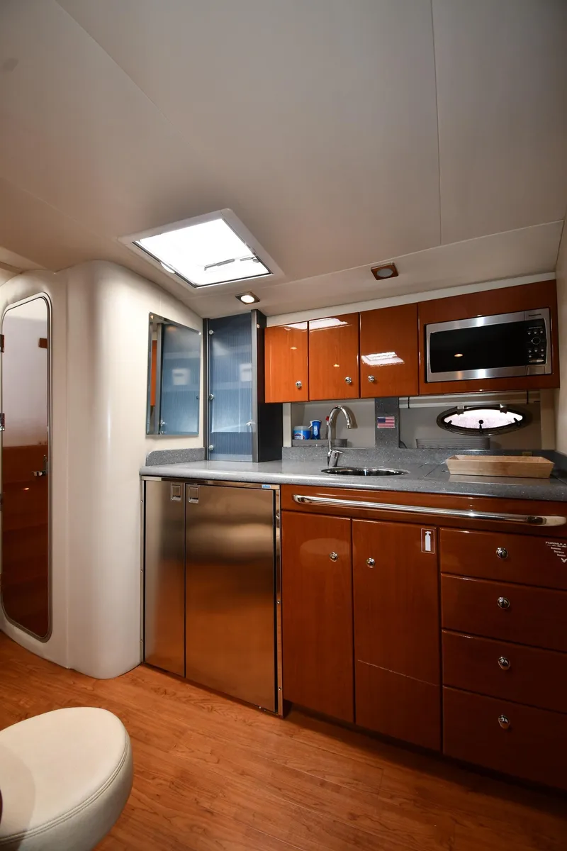 Slide: The Image of 2009 Formula 40 PC yacht interior with modern kitchen, wood cabinets, and stainless steel appliances. - 45