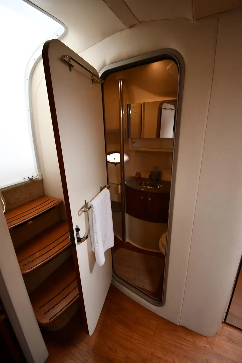 Slide: The Image of 2009 Formula 40 PC yacht interior with open bathroom door and wooden steps. - 48