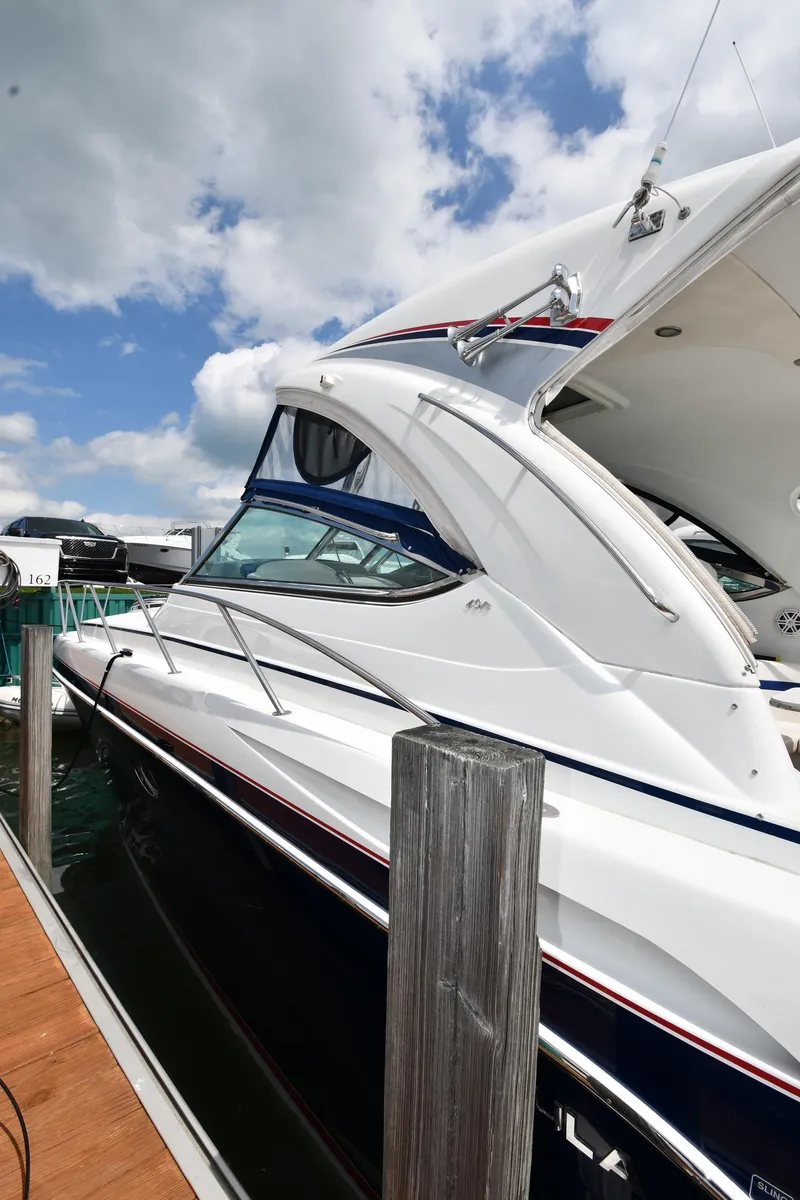 Slide: The Image of 2009 Formula 40 PC yacht docked under a partly cloudy sky. - 7