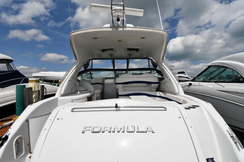 Slide: The Image of 2009 Formula 40 PC yacht docked under a partly cloudy sky. - 9