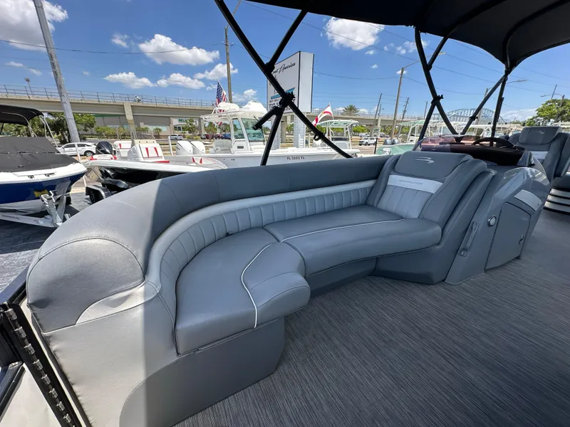 Slide: The Image of 2021 Bennington LX 24 Stern Lounge with luxurious seating and sleek design under a sunny sky. - 19