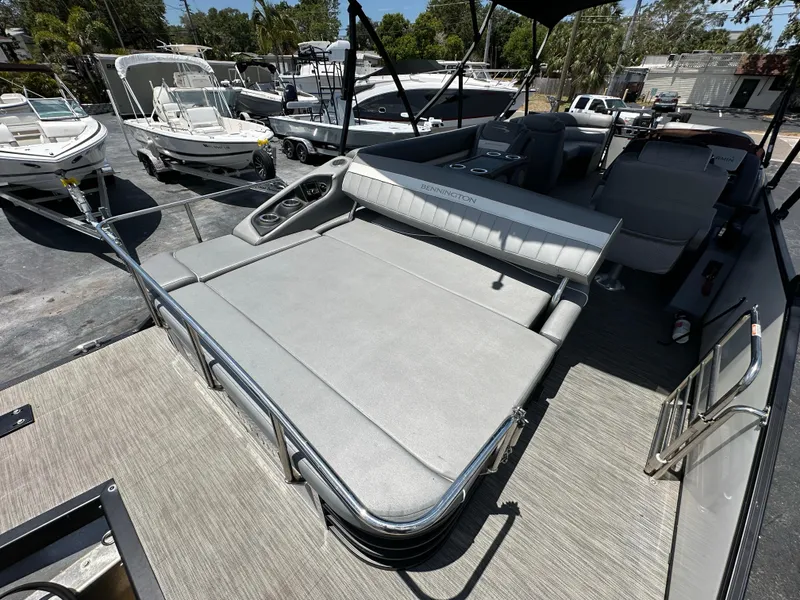 Slide: The Image of 2021 Bennington LX 24 Stern Lounge boat with spacious seating and sleek design. - 7