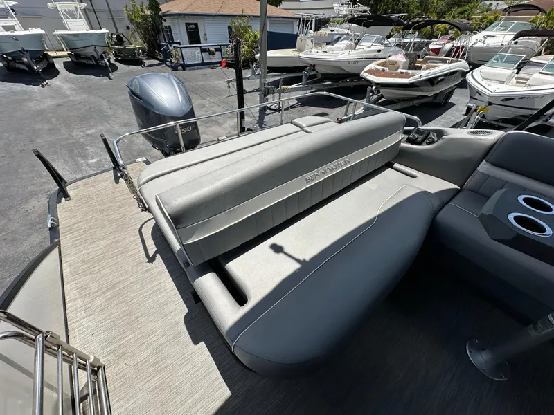 Slide: The Image of 2021 Bennington LX 24 Stern Lounge boat with gray seating and cup holders. - 9