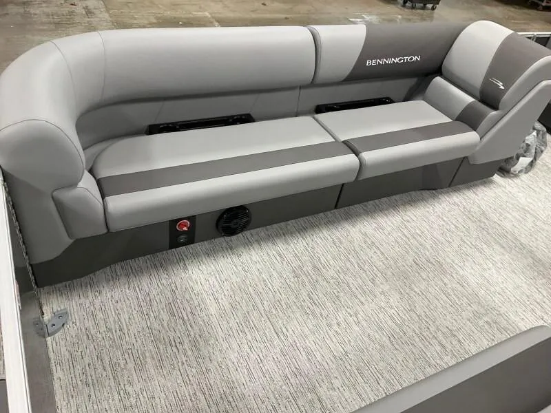 Slide: The Image of 2025 Bennington 23SSR-SPS (PB) boat interior with gray seating and carpeted flooring. - 11