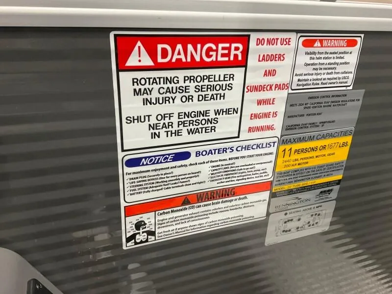 Slide: The Image of Safety warning labels on a 2025 Bennington 23SSR-SPS (PB) boat, highlighting propeller dangers. - 13