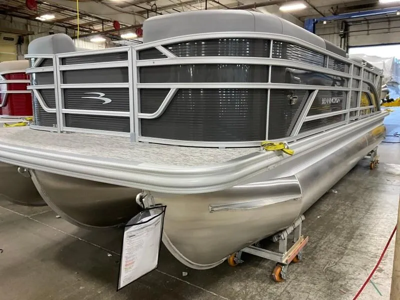 Slide: The Image of 2025 Bennington 23SSR-SPS pontoon boat in a warehouse setting. - 4