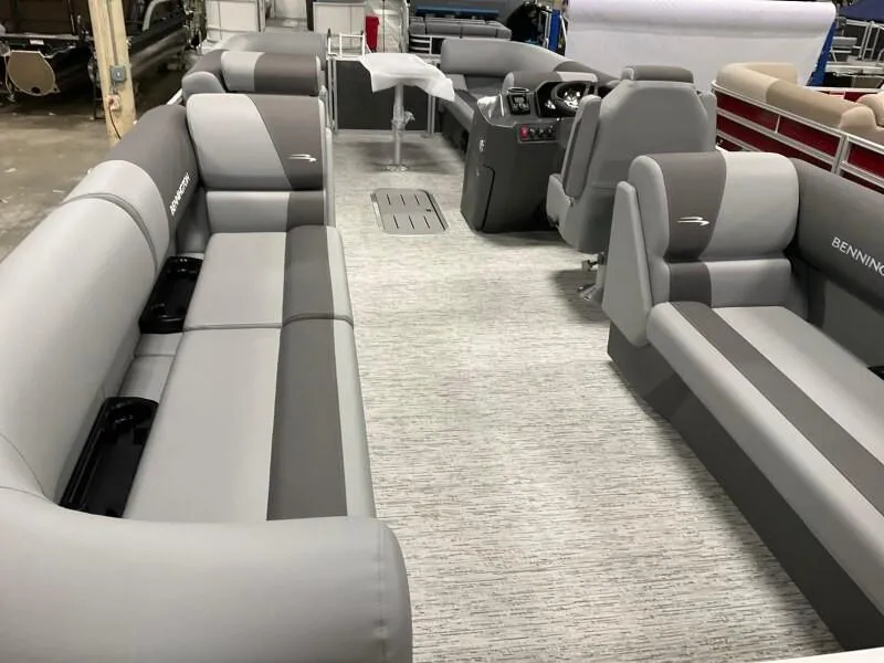 Slide: The Image of 2025 Bennington 23SSR-SPS pontoon boat interior with gray seating and modern helm. - 9