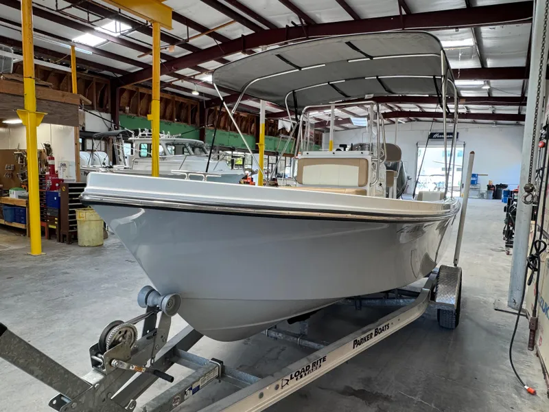 Slide: The Image of 2019 Parker 1801 CC boat on trailer in a warehouse setting. - 2