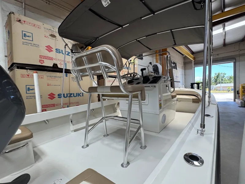 Slide: The Image of 2019 Parker 1801 CC boat interior with Suzuki outboard motor boxes in a garage. - 5