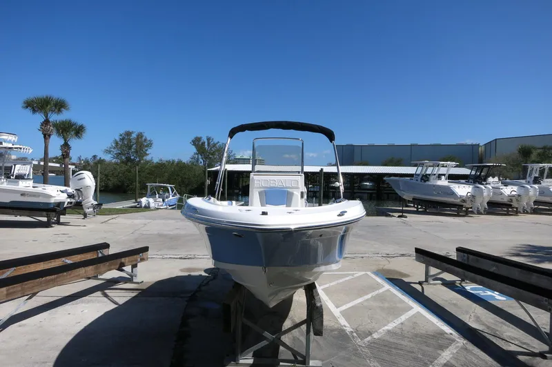 Slide: The Image of 2025 Robalo R180 Center Console boat displayed outdoors on a sunny day. - 13