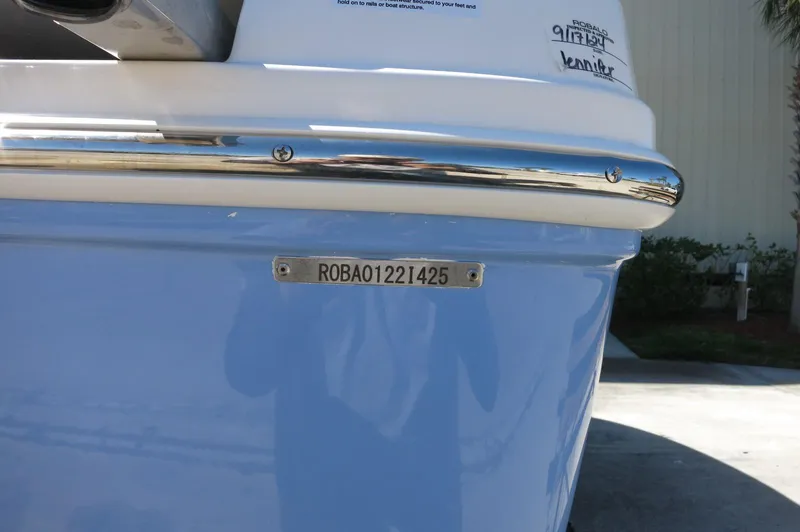 Slide: The Image of 2025 Robalo R180 Center Console boat with visible hull identification number. - 18