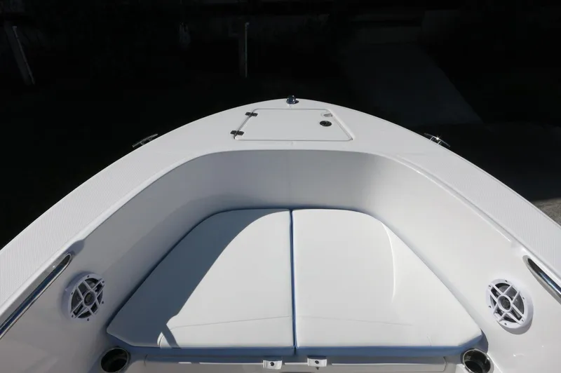Slide: The Image of 2025 Robalo R180 Center Console boat bow with seating and storage compartments. - 20