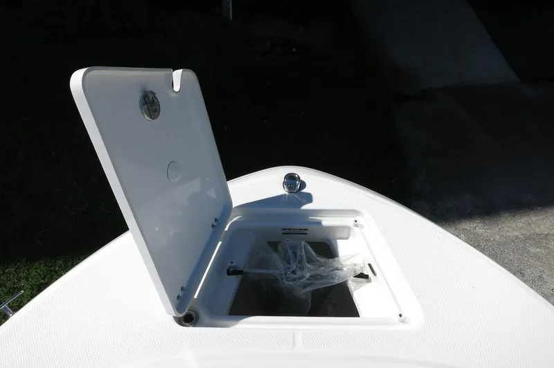 Slide: The Image of Open storage compartment on 2025 Robalo R180 Center Console boat. - 21