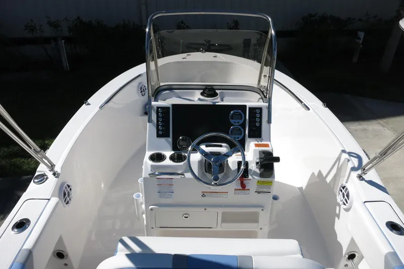Slide: The Image of 2025 Robalo R180 Center Console boat interior with steering wheel and control panel. - 29