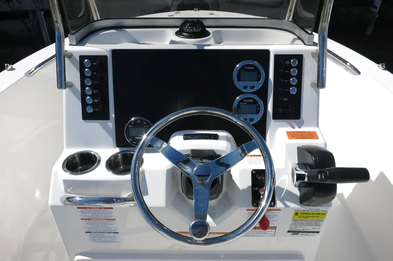 Slide: The Image of 2025 Robalo R180 Center Console dashboard with steering wheel and control panel. - 30