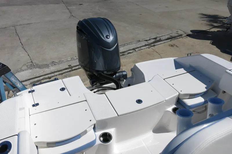 Slide: The Image of 2025 Robalo R180 Center Console boat with outboard motor, featuring a sleek white deck design. - 33