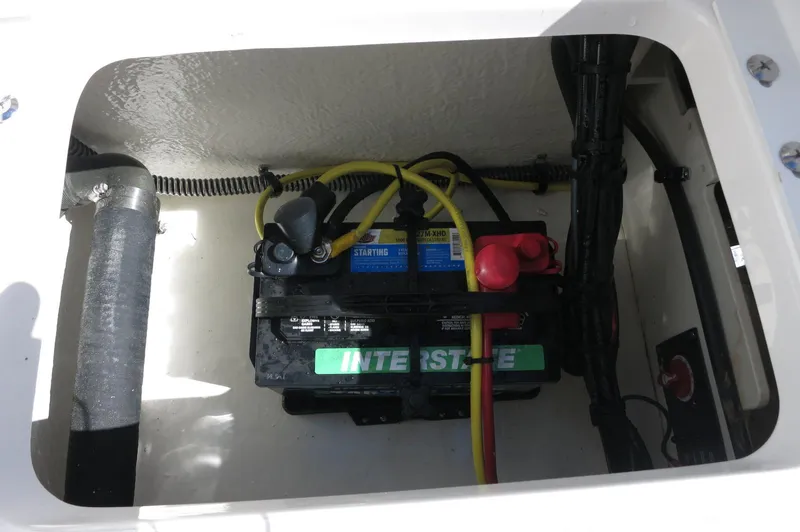 Slide: The Image of Battery compartment of 2025 Robalo R180 Center Console boat, featuring Interstate battery. - 36
