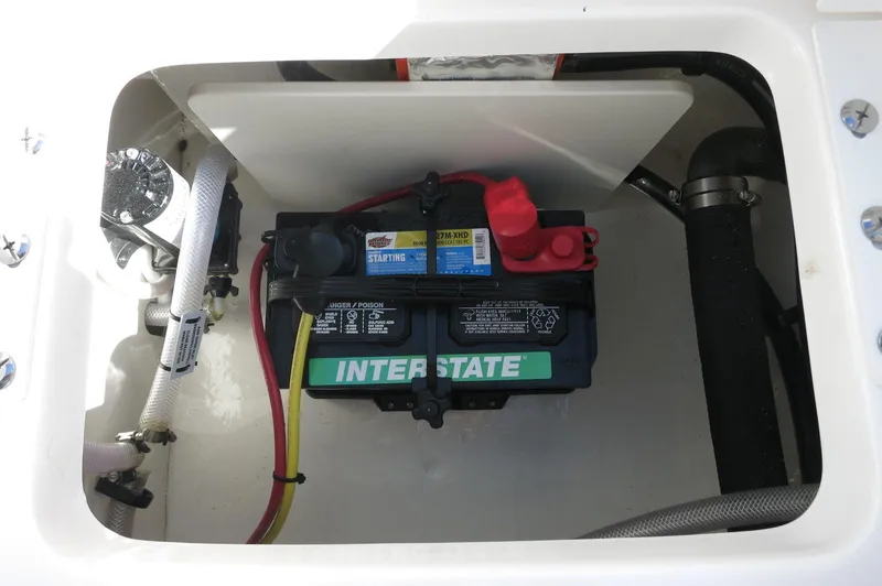 Slide: The Image of 2025 Robalo R180 Center Console boat battery compartment with Interstate battery. - 37