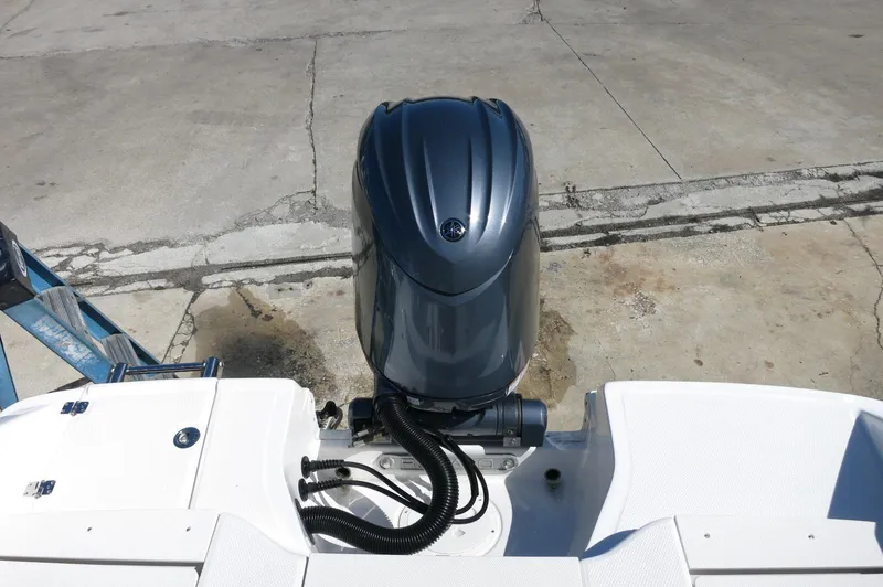 Slide: The Image of 2025 Robalo R180 Center Console boat with outboard motor on concrete surface. - 38
