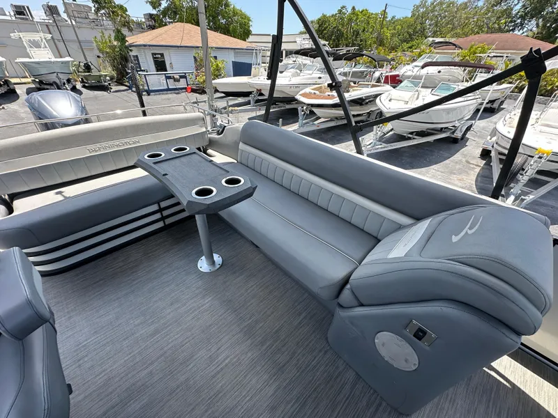 Slide: The Image of 2021 Bennington LX 24 Swingback pontoon boat with gray seating and cup holders. - 11