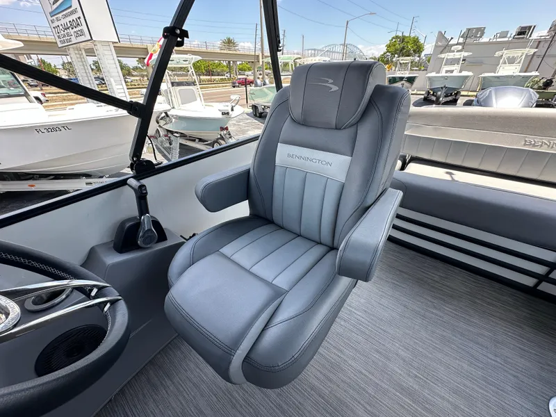 Slide: The Image of Captain's chair in 2021 Bennington LX 24 Swingback pontoon boat, featuring sleek gray upholstery. - 13