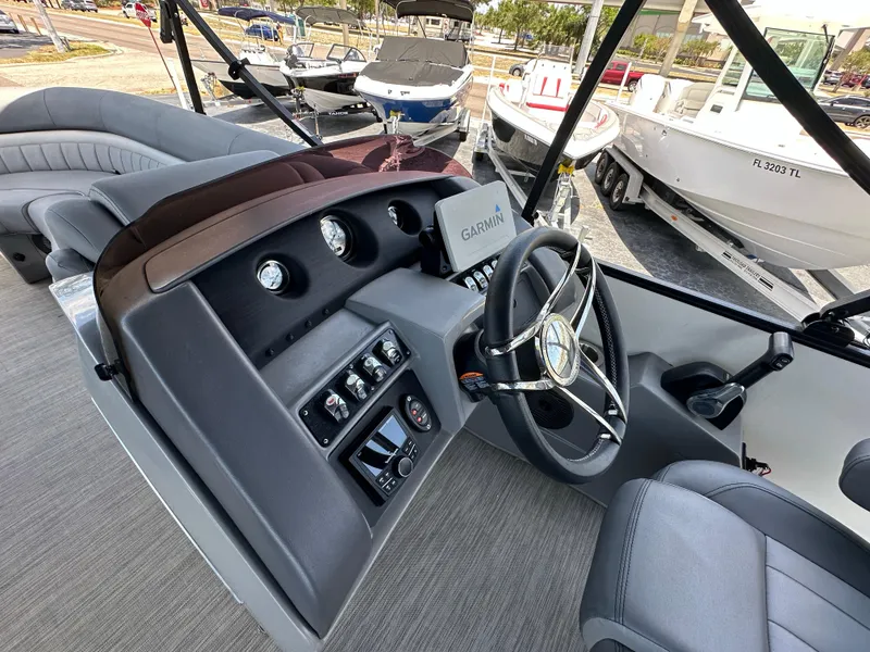 Slide: The Image of Interior view of 2021 Bennington LX 24 Swingback boat with steering wheel and control panel. - 14