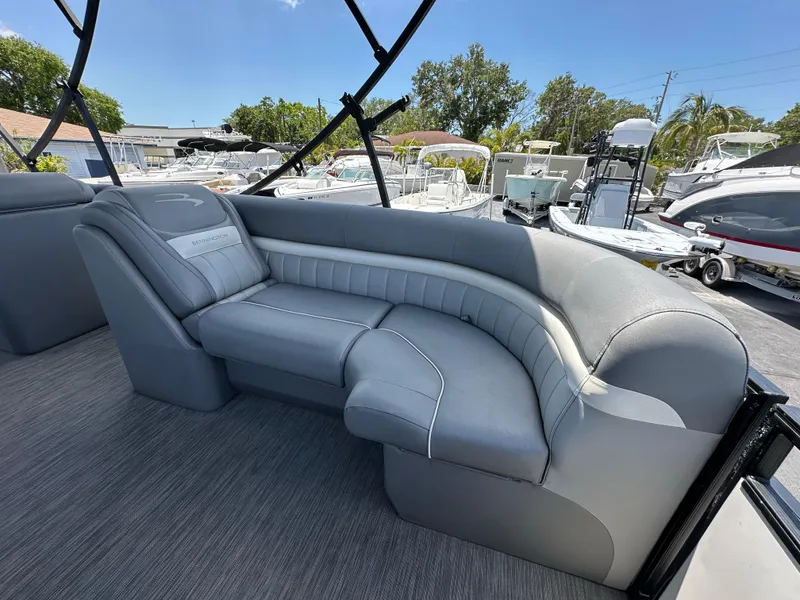 Slide: The Image of Luxurious seating on 2021 Bennington LX 24 Swingback pontoon boat, featuring sleek gray upholstery. - 19
