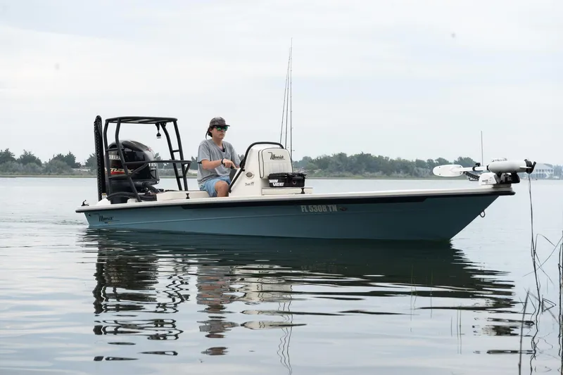 The Image of 2023 Maverick 18 HPX-V boat on calm water with a person steering. - 0