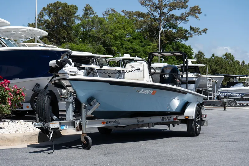 Slide: The Image of 2023 Maverick 18 HPX-V boat on trailer, parked outdoors near other boats. - 10