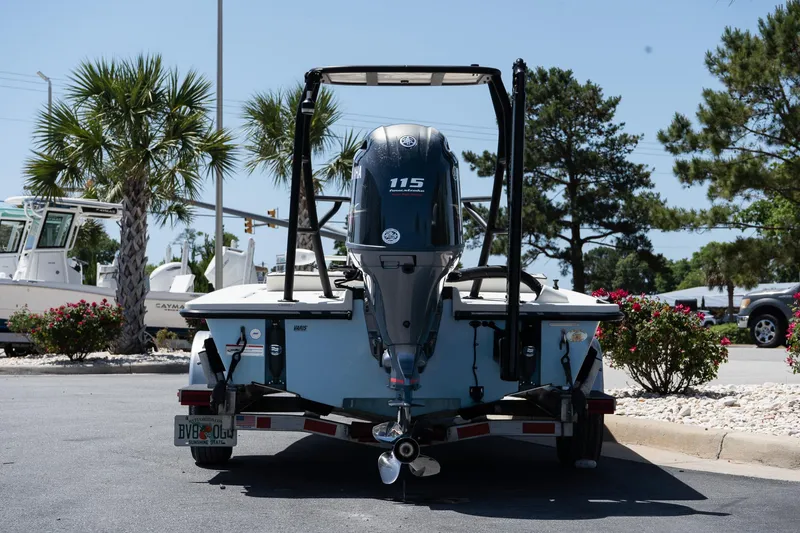 Slide: The Image of 2023 Maverick 18 HPX-V boat with Yamaha 115 engine, parked outdoors. - 11