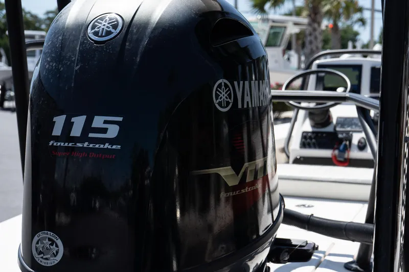 Slide: The Image of 2023 Maverick 18 HPX-V boat with Yamaha 115 four-stroke engine, docked outdoors. - 13