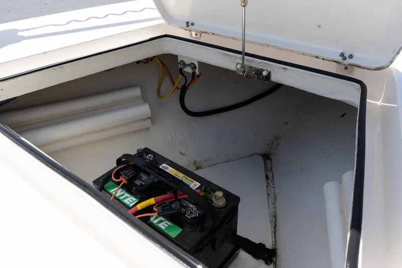 Slide: The Image of 2023 Maverick 18 HPX-V boat battery compartment with wiring and storage space. - 24