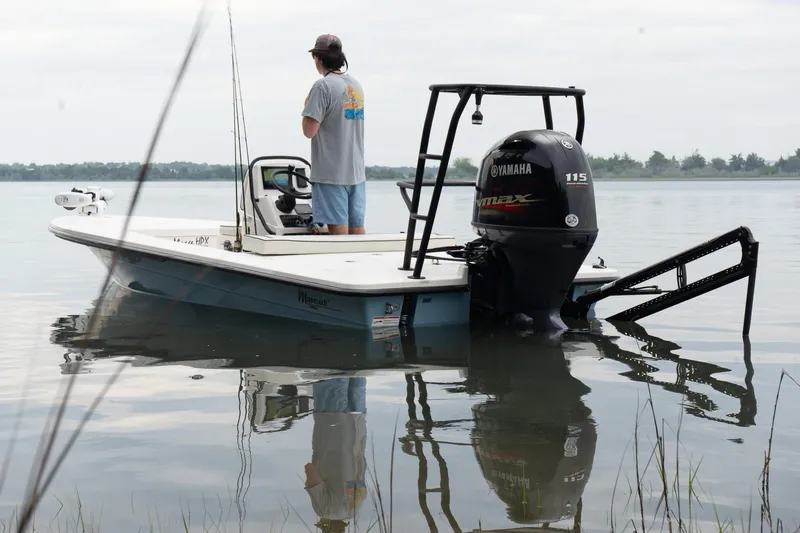 Slide: The Image of 2023 Maverick 18 HPX-V boat with Yamaha engine on calm water, person standing onboard. - 3