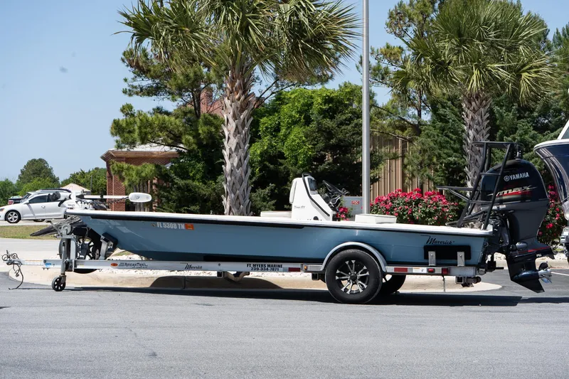 Slide: The Image of 2023 Maverick 18 HPX-V boat on trailer, parked near palm trees. - 7