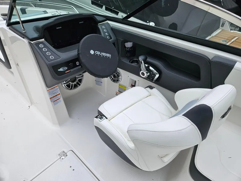 Slide: The Image of 2025 Chaparral 247 SSX boat cockpit with modern steering and white seating. - 10
