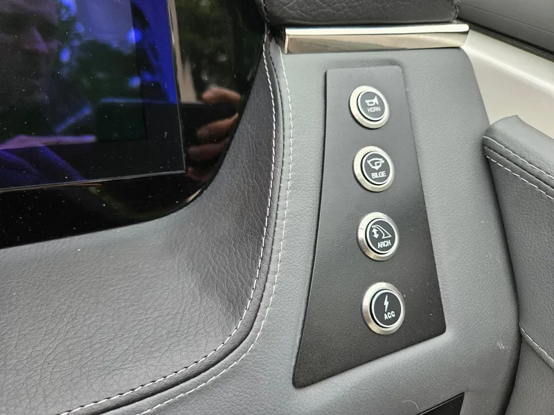 Slide: The Image of Dashboard controls of 2025 Chaparral 247 SSX boat, featuring sleek design and modern buttons. - 11