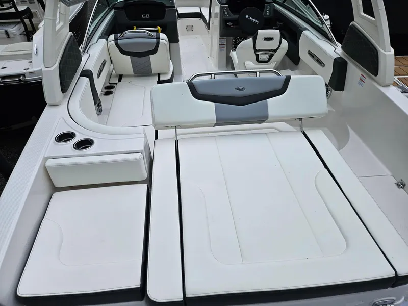 Slide: The Image of 2025 Chaparral 247 SSX boat interior with white seating and modern design. - 3