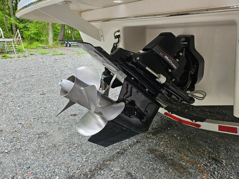Slide: The Image of 2025 Chaparral 247 SSX boat propeller and outdrive on gravel surface. - 36