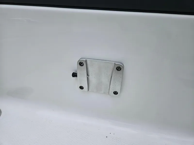 Slide: The Image of 2025 Chaparral 247 SSX boat detail, featuring a mounted metal component on the white surface. - 40