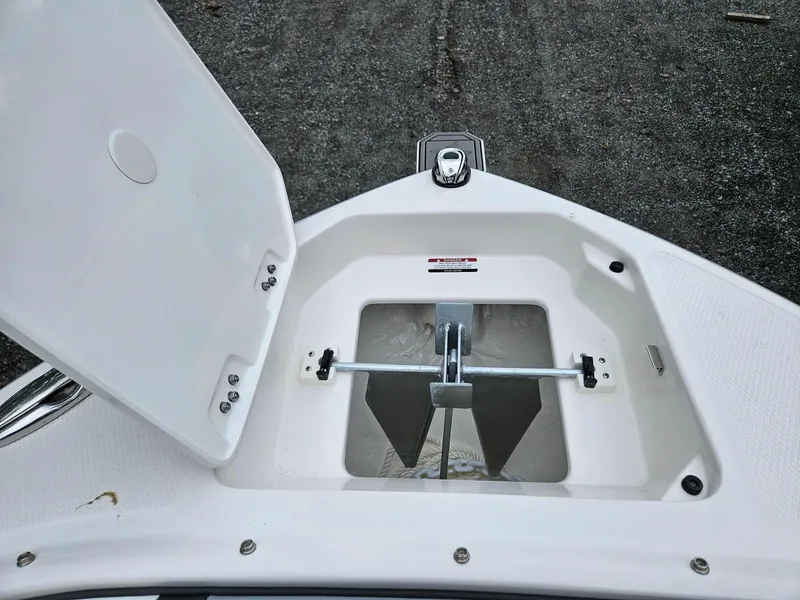 Slide: The Image of Open anchor compartment on 2025 Chaparral 247 SSX boat, showcasing anchor storage. - 43