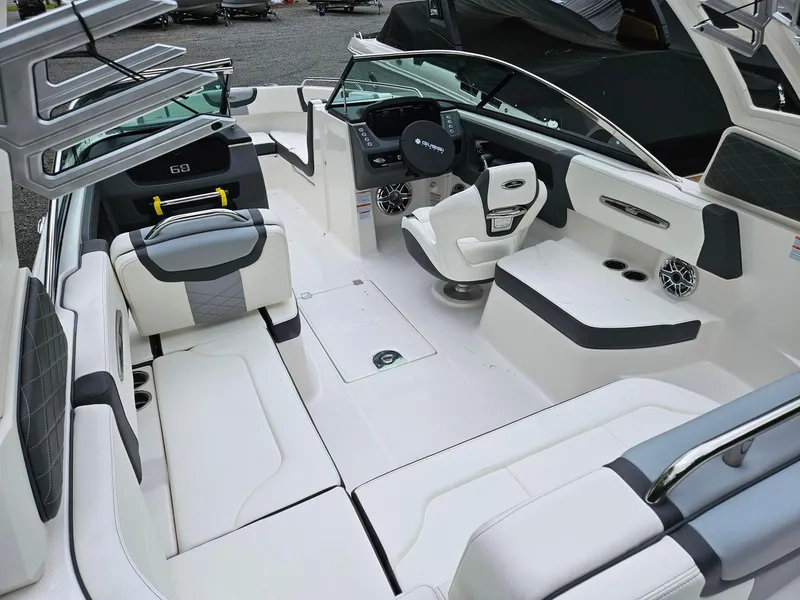 Slide: The Image of 2025 Chaparral 247 SSX boat interior with white seating and modern dashboard. - 5