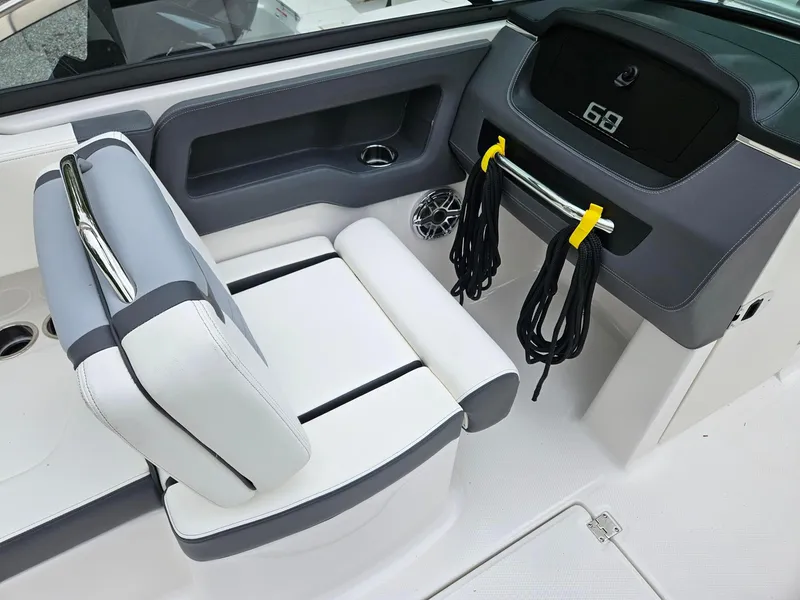 Slide: The Image of 2025 Chaparral 247 SSX boat interior with sleek seating and dashboard design. - 8