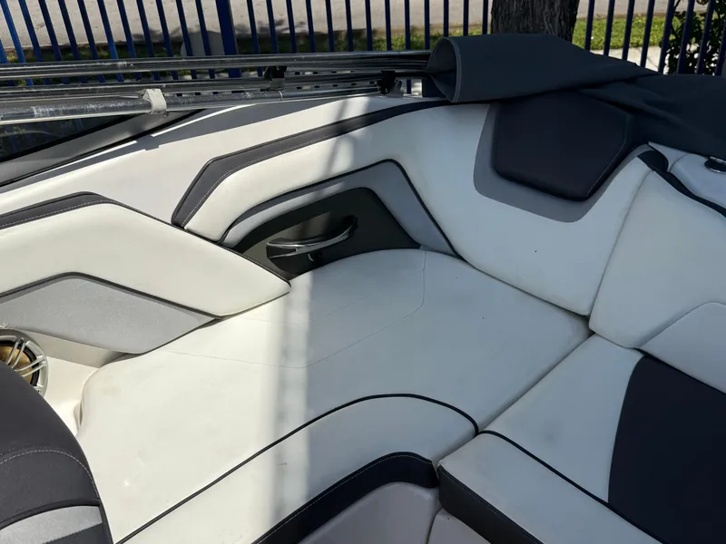 Slide: The Image of 2015 Yamaha Boats SX192 interior seating with white and gray upholstery. - 11